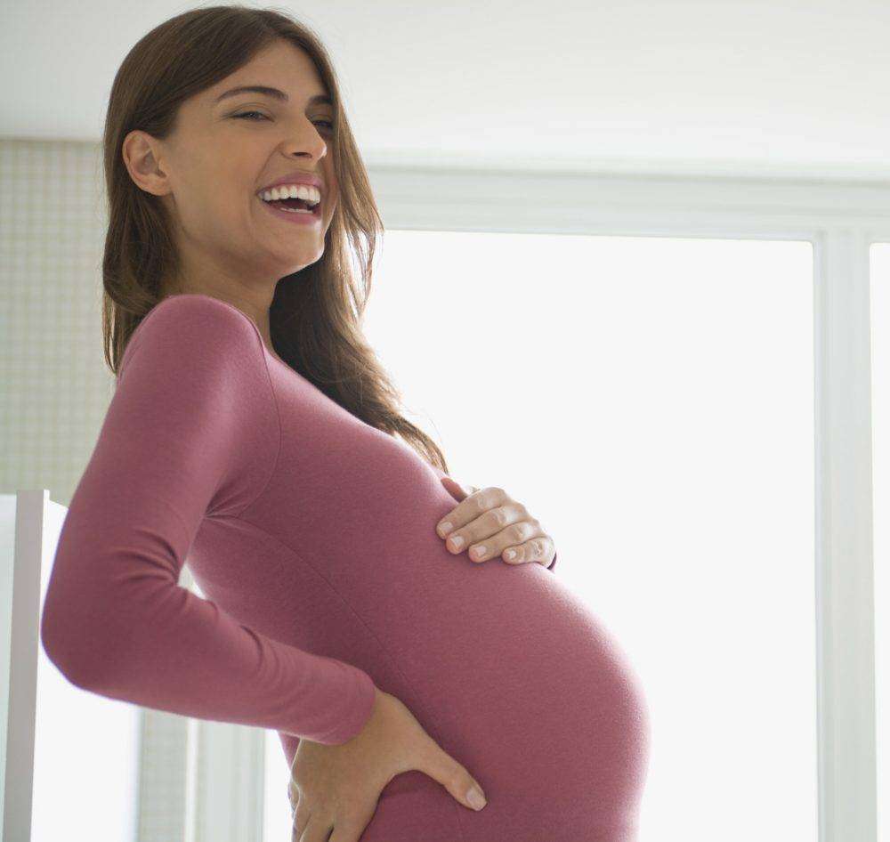 Pregnant woman laughing